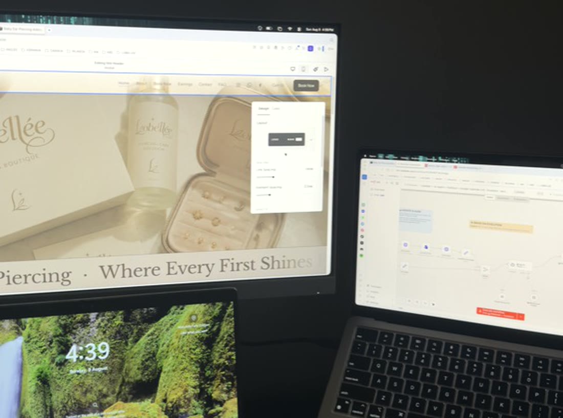 The Lobellee website being built on one screen with the automation workflow running on another